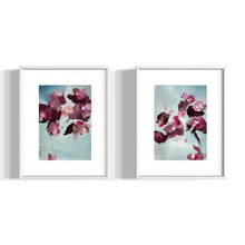 Load image into Gallery viewer, Pair of framed abstract floral paintings with soft pink and plum tones on blue backgrounds, modern botanical wall art in white frames.
