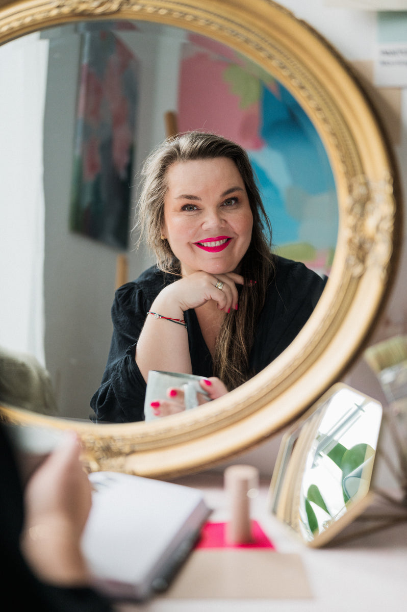Artist in her studio, smiling in the mirror, Dominika Montonen-Koivisto